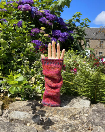 Hand knitted wrist warmers on hand